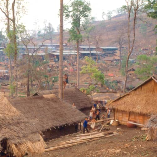 Thatched houses on a hillside at Ban Vinai